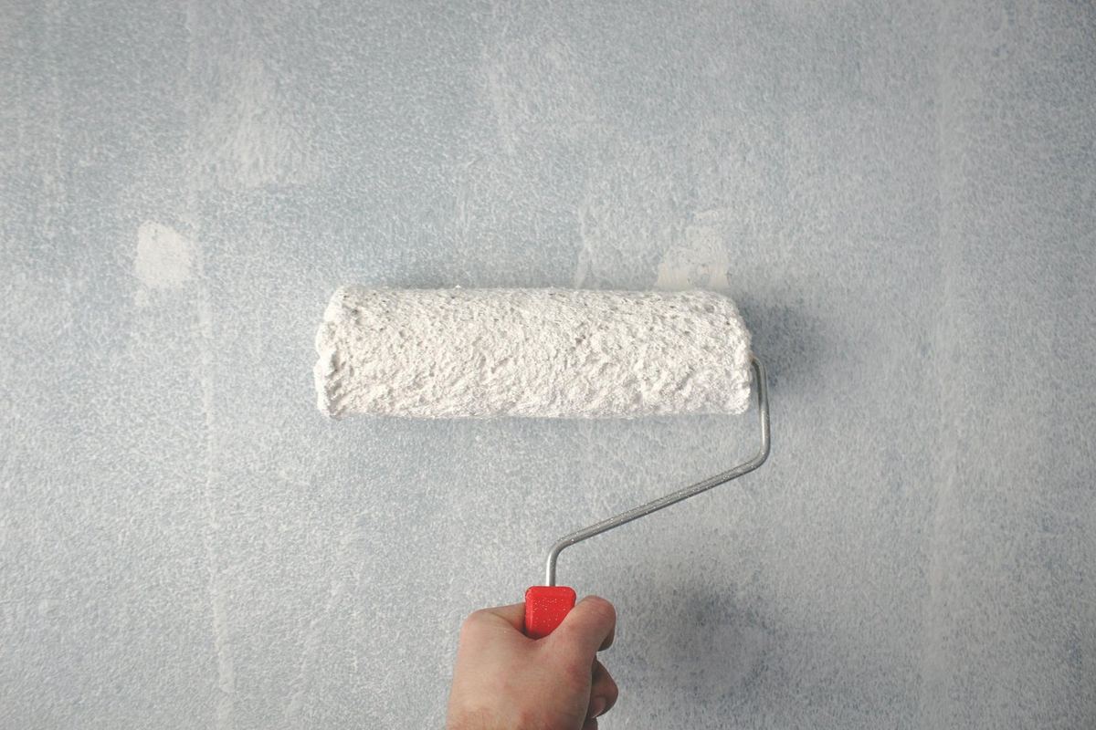 TMN painter applying paint with a roller